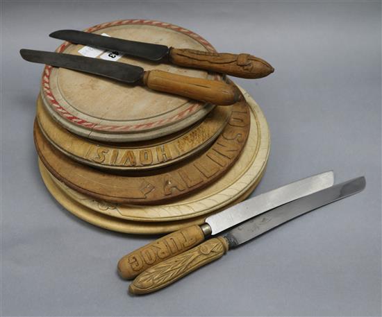 Five carved bread boards plus four carved handled bread knives largest diameter 30cm